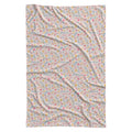 A rectangular swaddle blanket with a delicate, all-over repeating pattern of small birds, flowers, and the name 'AMELIA' printed in blue. The blanket is laid flat against a solid white background.