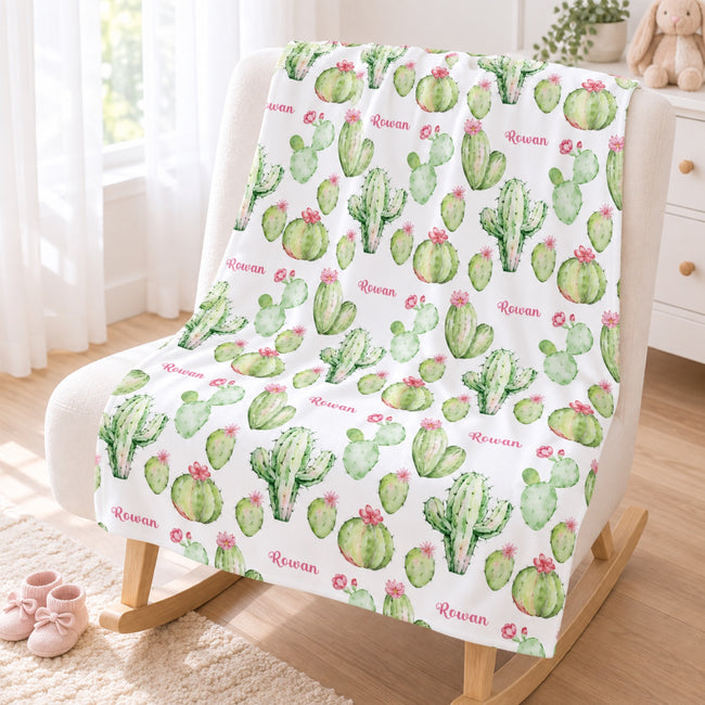 Personalized Pink Cactus Baby Girl Blanket. Watercolor green cacti topped with pink blossoms bring cheerful desert charm to a custom name.