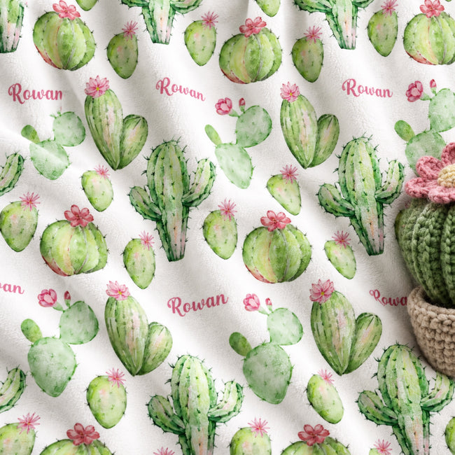 Personalized Pink Cactus Baby Girl Blanket. Watercolor green cacti topped with pink blossoms bring cheerful desert charm to a custom name.