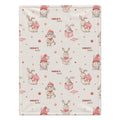 A blanket featuring a repeating pattern of cute cartoon rabbits wearing red Santa hats and holding pink hearts, with the name 'Charlotte' printed in red text.