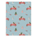 A personalized blanket featuring a light blue background with a repeating Christmas-themed pattern of red pickup trucks, snowmen, snow globes, and Christmas trees. 