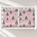 A white changing table with a personalized changing pad cover featuring a Christmas tree pattern.