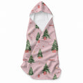 Blush pink hooded towel featuring decorated Christmas trees, presents, stars, bunnies in gift boxes, and the name Charlotte Anne.
