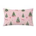 A rectangular pink pillow sham featuring a watercolor Christmas tree pattern with red gift boxes, gold stars, and the text 'CHARLOTTE love' repeated across the design.