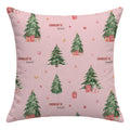 A square pink throw pillow featuring a repeating Christmas tree pattern with wrapped presents, gold stars, and the text 'CHARLOTTE annl' in brown and black script.