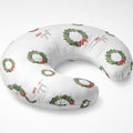 A U-shaped maternity pillow with a white background, decorated with green holly wreaths with red bows and red 'Joy of Life' script text.