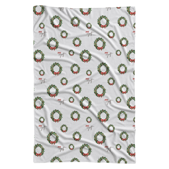 Personalized Christmas wreath swaddle blanket with evergreen branches, red bows and optional baby name