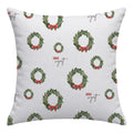 A square throw pillow with a white background featuring a repeating pattern of green Christmas wreaths with red bows and the text 'Jack Wyatt' in brown script.