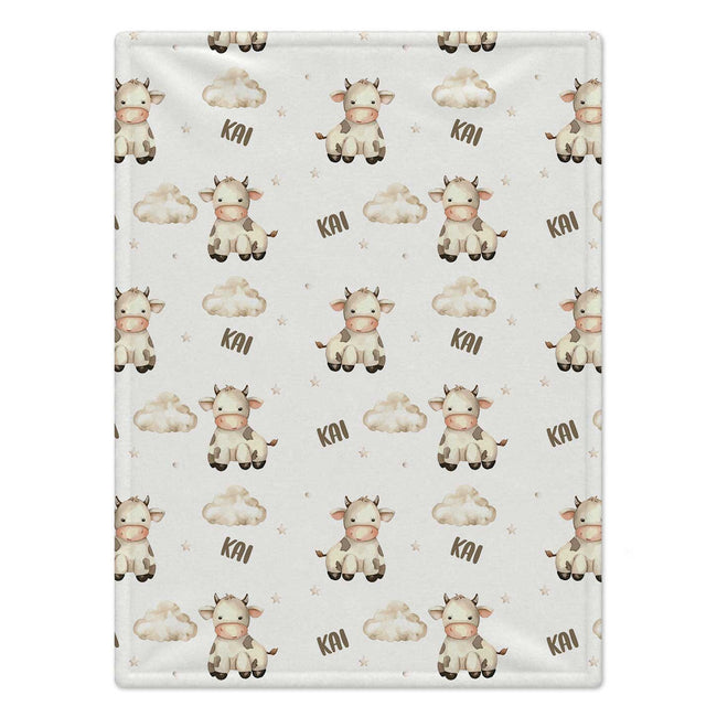 Personalized Cow Baby Blanket. Sweet cows and soft cloud details create a gentle countryside setting for a custom name.