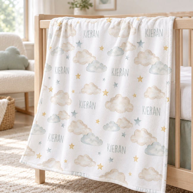 Personalized Cloud and Star Baby Blanket. Dreamy clouds and delicate stars surround a custom name in a soft, soothing palette.