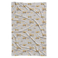 A swaddle blanket with a light gray background and an all-over repeating pattern of yellow construction vehicles and the word 'MASON' in black.
