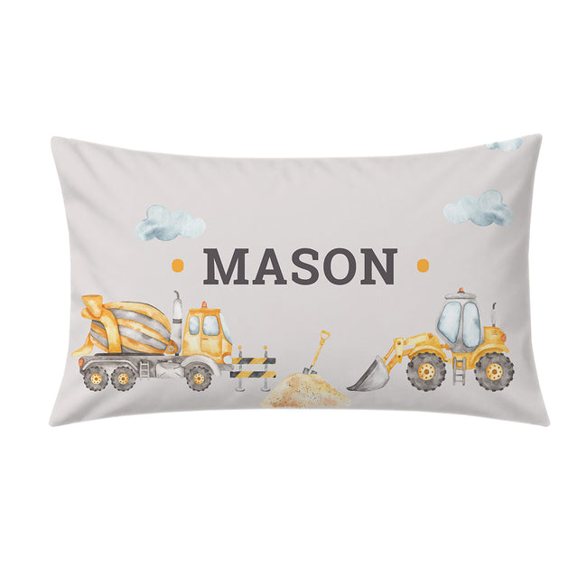 A personalized rectangular pillow featuring a construction-themed design with the name 'MASON' in dark gray text, flanked by a yellow cement mixer truck and a yellow bulldozer, on a light gray background.
