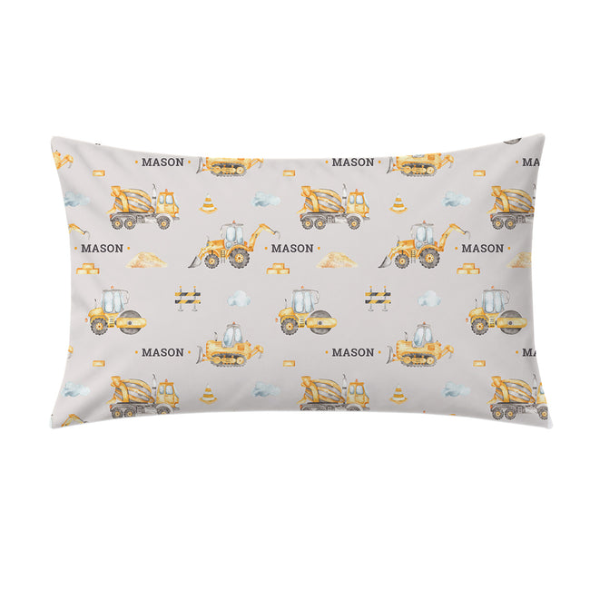 A rectangular throw pillow with a light gray background and a repeating construction-themed print featuring yellow and orange machinery, blue clouds, and the word 'MASON' in black.