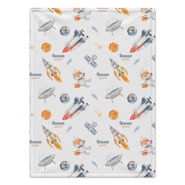 Personalized Space Fox Baby Blanket. An adventurous astronaut fox, rockets, and planets bring a playful little universe to a custom name.