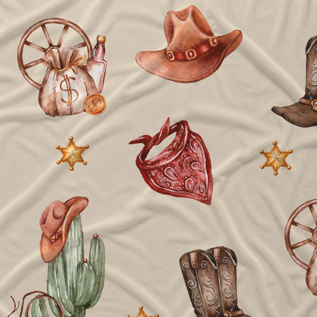 Western-themed fabric print featuring watercolor-style illustrations of cowboy hats, boots, a cactus with a hat, a money sack with a dollar sign, sheriff star badges, and a red bandana on a light beige background.