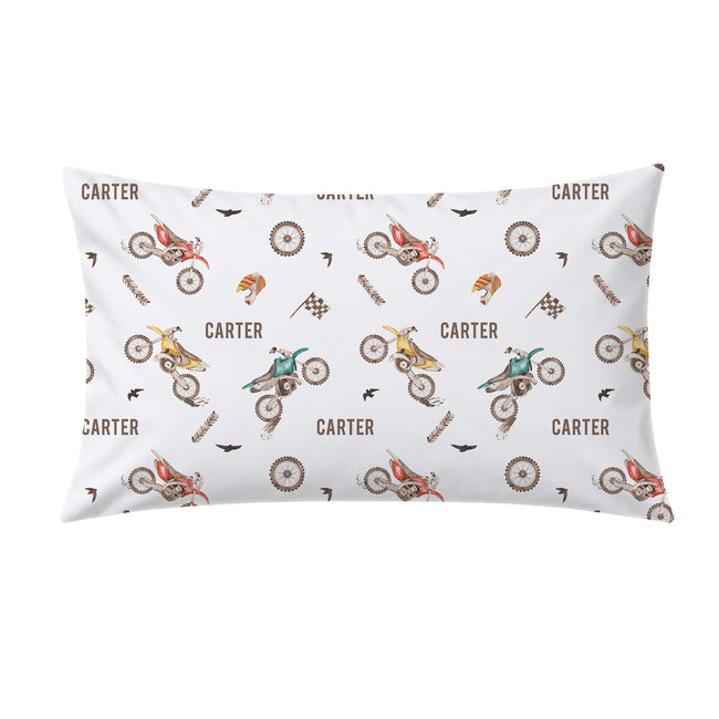A rectangular white pillow sham featuring a repeating pattern of vintage-style dirt bikes, wheels, birds, and the name 'CARTER' in brown text.