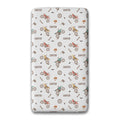 A twin fitted sheet featuring a repeating pattern of vintage-style dirt bikes, racing helmets, and the name 'CARTER' printed in brown on a light gray background.