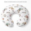 A U-shaped nursing pillow cover with a white background and a repeating pattern of vintage-style dirt bikes and the name 'CARTER' in brown. The text 'ORIGINAL AND NEW NURSING PILLOW COVERS AVAILABLE!' is printed at the top of the image.