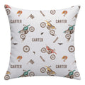 A square throw pillow featuring a repeating cartoon-style dirt bike and rider pattern with the name 'CARTER' printed across a light gray background.