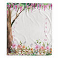 Enchanted Garden baby girl milestone blanket with hanging pink blossoms, a watercolor tree, flowers, and numbers 1–12.