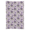 Pale lavender swaddle blanket with purple violet flowers, green leaves, and the name Violet Mae in purple and green lettering.