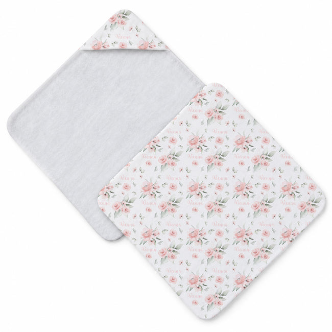 Two square baby towel with rounded corners in a white background with a pink and green floral print, displayed on a clean white background.