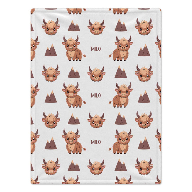 Personalized Highland Cow Baby Blanket. Fluffy highland cows and warm earthy details surround a custom name in a charming rustic design.