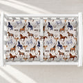 A white changing table with a personalized changing pad cover featuring a western-themed print of horses, horseshoes, and chickens on a light beige background. The set is displayed inside a white wooden crib.