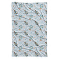 A swaddle blanket featuring a repeating pattern of blue and orange striped hot air balloons, small hearts, and the text 'COLTON PYPF' on a light blue background.