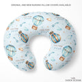 Personalized U-shaped nursing pillow cover featuring a light blue background with a watercolor hot air balloon pattern and the text 'COLTON joseph' printed on it. The pillow is displayed on a clean white background with promotional text at the top and the brand logo 'CAIDEN DESIGNS' at the bottom right.