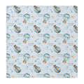 A square personalized swaddle blanket featuring a repeating pattern of blue and gold hot air balloons, small hearts, stars, and the text 'COLTON & joseph' on a pale blue background.