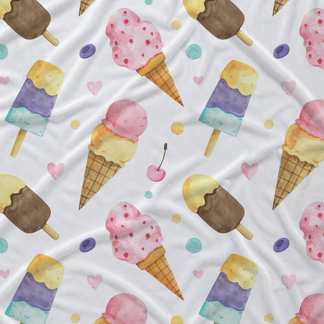 A white fabric surface printed with a repeating watercolor pattern of ice cream cones, popsicles, cherries, and pastel dots in pink, yellow, blue, purple, and brown.