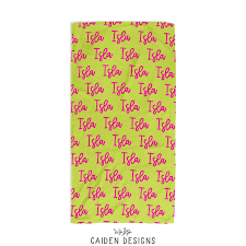 A personalized beach towel, featuring a repeating pattern of pink cursive script on a bright lime green background. The brand name 'CAIDEN DESIGNS' is printed in black at the bottom center.
