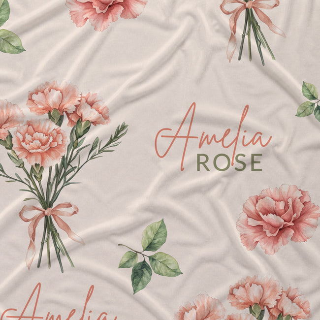 Cream fabric with peach-pink carnation bouquets, green leaves, and the name Amelia Rose in coral and green lettering.