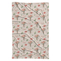 Cream swaddle blanket with peach-pink carnation bouquets, green leaves, and the name Amelia Rose in coral and green lettering.