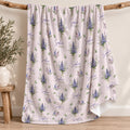 Pale blush blanket with blue and lavender larkspur bouquets, green leaves, and the name Sophia Kate in blue and green lettering.