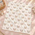 Personalized Kitten Baby Blanket. Sweet kitten faces surround a custom name in a soft, simple design with warm neutral tones.