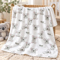 A white blanket with a repeating pattern of gray koala illustrations and the names 'Knox William' is draped over a wicker basket in a cozy room setting with a plush koala toy nearby.