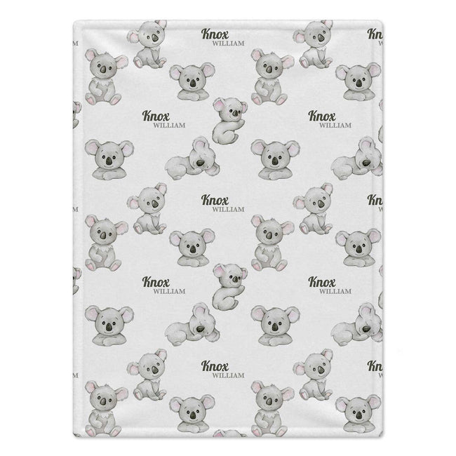 Personalized Koala Baby Blanket. Adorable baby koalas surround a custom name in a gentle grey watercolor design.
