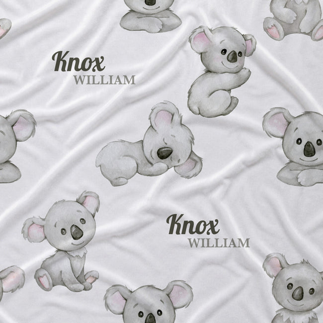 White personalized baby blanket featuring a repeating pattern of watercolor koala bears and the custom name 'Knox William' in dark gray text.