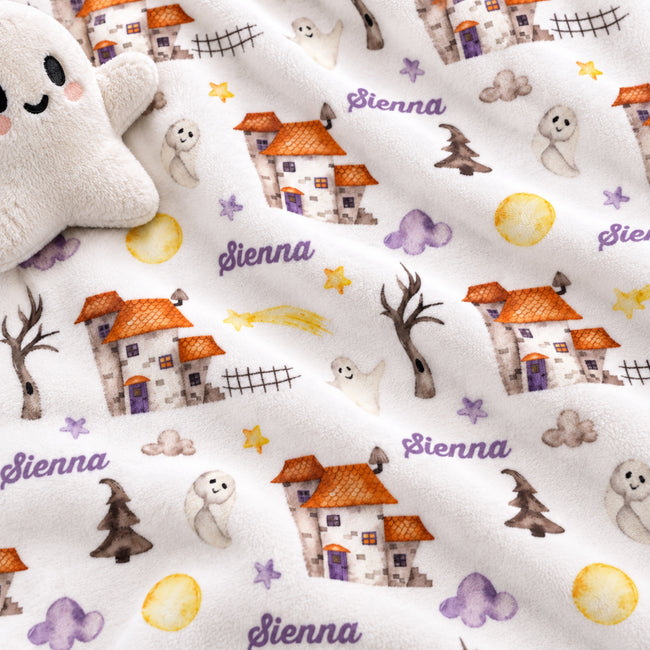 Personalized Halloween Baby Blanket. Playful Halloween characters and cheerful seasonal details surround a custom name in a festive design.
