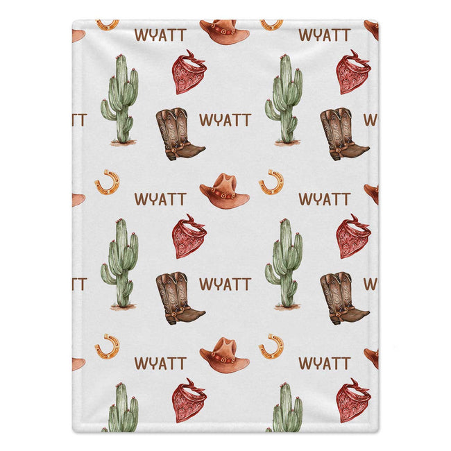 Personalized Cowboy Baby Boy Blanket. Cowboy hats, boots, bandanas, and cacti bring warm western charm to a custom name.