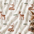 Personalized Deer Baby Blanket. Gentle baby deer and delicate woodland greenery surround a custom name in soft earthy tones.