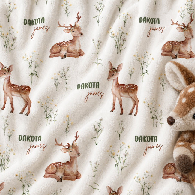 Personalized Deer Baby Blanket. Gentle baby deer and delicate woodland greenery surround a custom name in soft earthy tones.