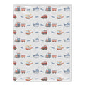 A rectangular baby blanket with a repeating pattern of various vehicles (trains, cars, boats, helicopters) in muted red, blue, and gray tones on a white background.