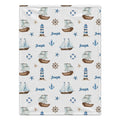 A rectangular blanket with a nautical-themed print featuring sailboats, lighthouses, anchors, life buoys, starfish, and ship wheels on an off-white background, personalized with the name 'Joseph' in blue script.