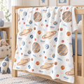 Personalized Planet Baby Blanket. Watercolor planets and celestial details surround a custom name in warm gold, blue, and earthy tones.