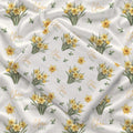 Ivory swaddle blanket with yellow daffodil clusters, green leaves, and the name Clara Mae in gold and sage green lettering.