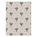Pale blush blanket with white lily of the valley bouquets, green leaves, and the name Lillian Grace in rose and green lettering.