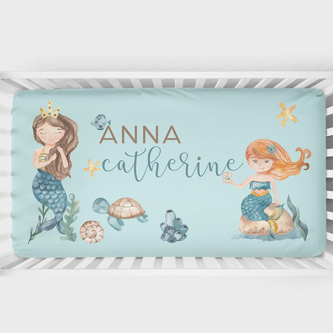 A personalized mermaid themed crib sheet